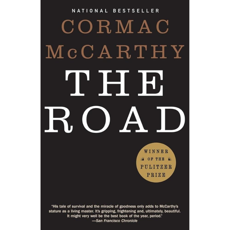Book cover of Cormac McCarthy's 'The Road' with a dark charcoal background, large white and tan title text, and a gold Pulitzer Prize badge.