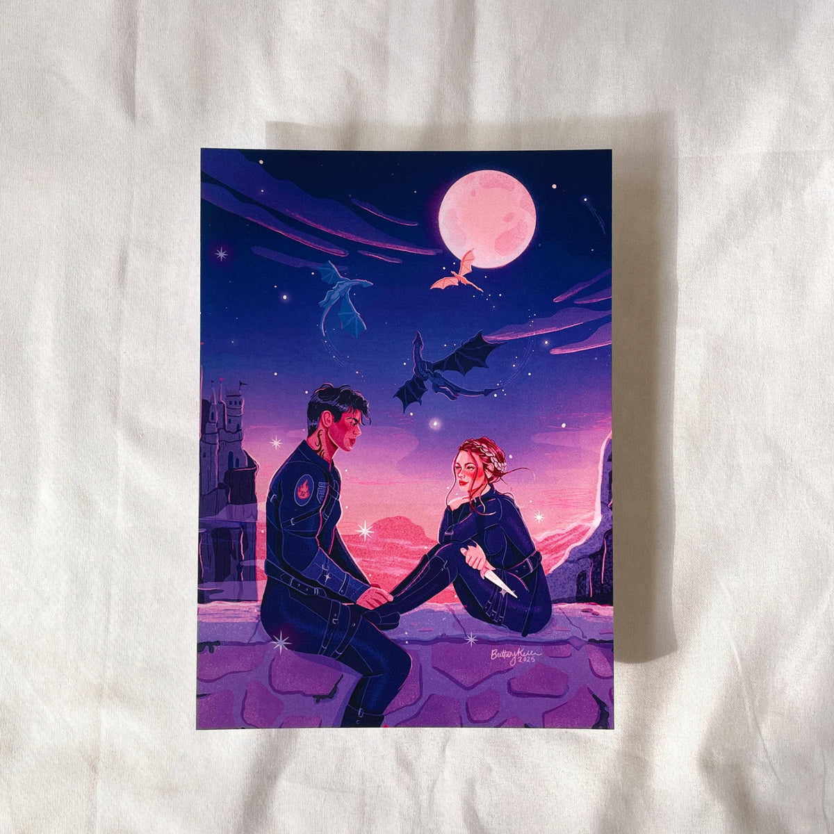 Illustration of two people sitting on a bench under a pink moon on a white fabric background