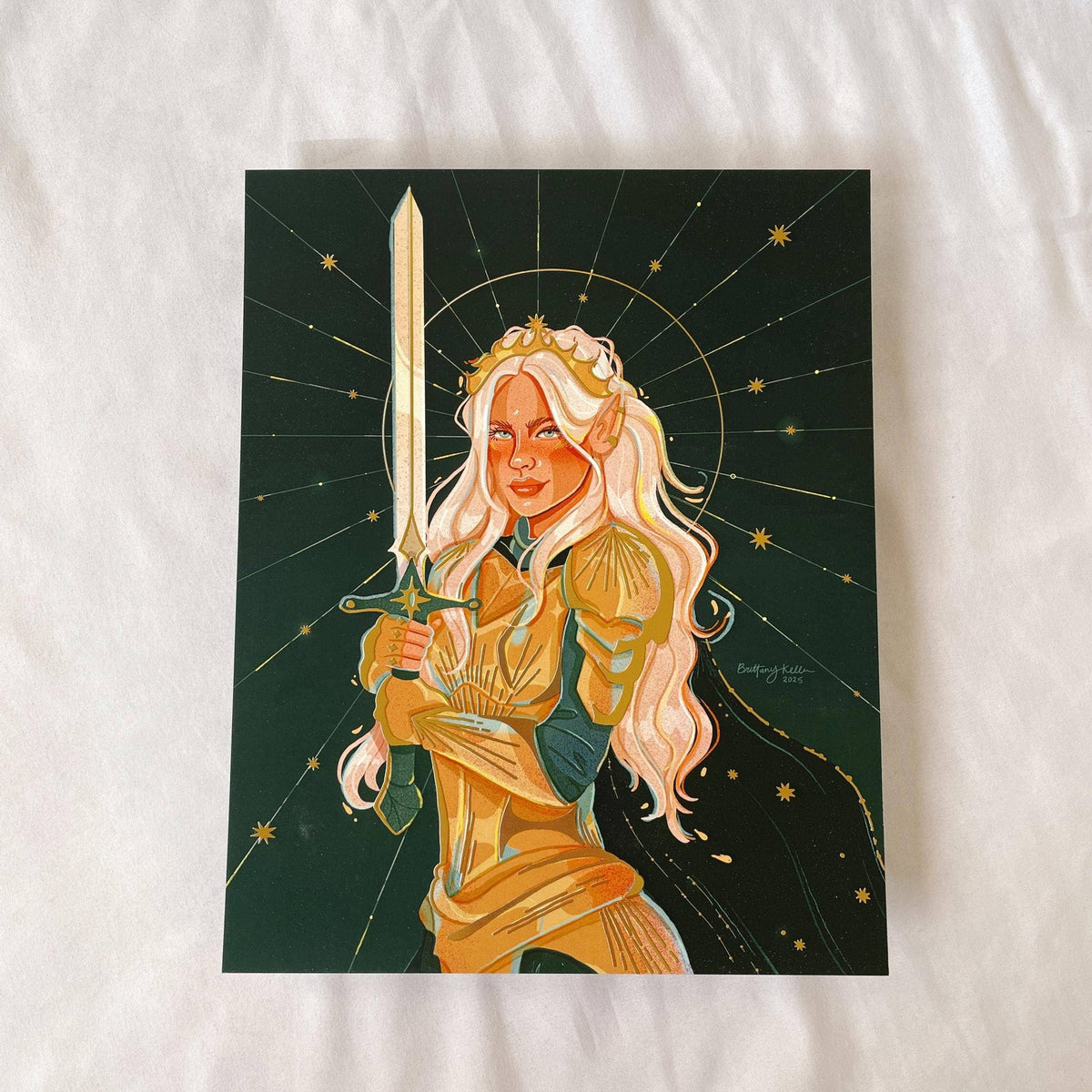 Artistic illustration of a woman in gold armor holding a sword on a dark background