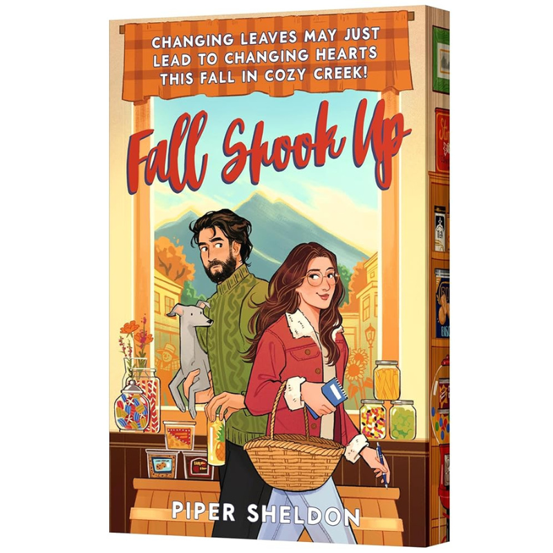 The book cover of 'Fall Shook Up' by Piper Sheldon, featuring an illustrated illustration of a man and woman in a cozy autumn setting with a cat and shelves of jars in the background.