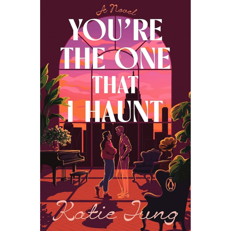 Book cover for 'You're the One That I Haunt' by Katie Jung, featuring a stylized illustration of a couple in a sunlit room with large white title text and a Penguin logo at the bottom.