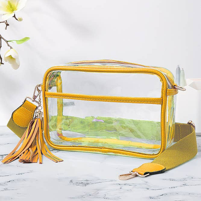 Clear bag with yellow strap and tassel on a marble surface