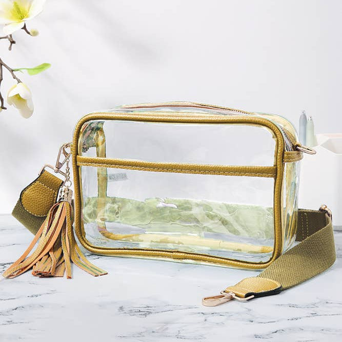 Clear pouch with gold trim and tassel on a marble surface