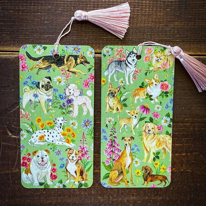 Two decorative bookmarks with dog illustrations on a wooden surface