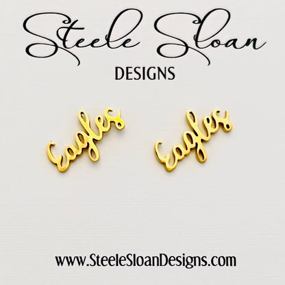 Gold 'Eagles' earrings with 'Steele Sloan Designs' branding on a light gray background.